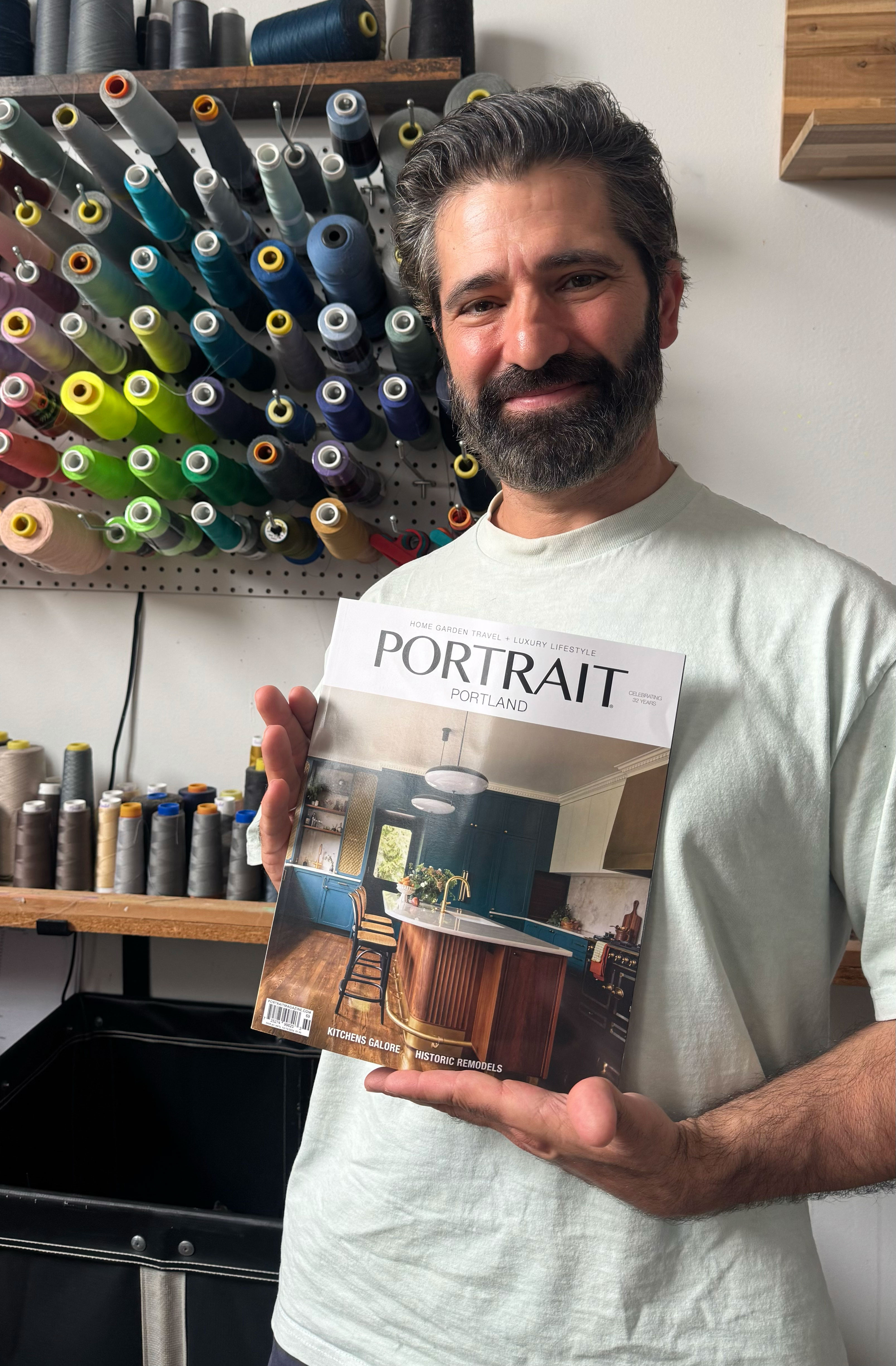george barberis holds a magazine with his images featured on the cover 