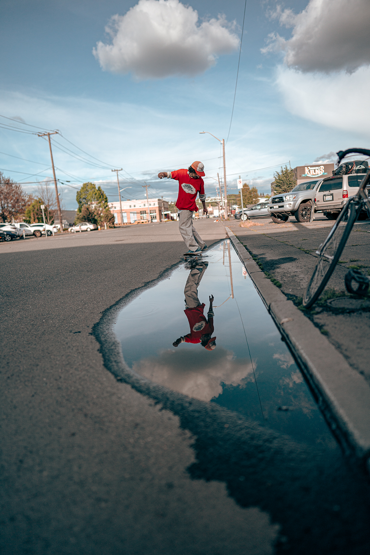 skateboarder goes through puddle 