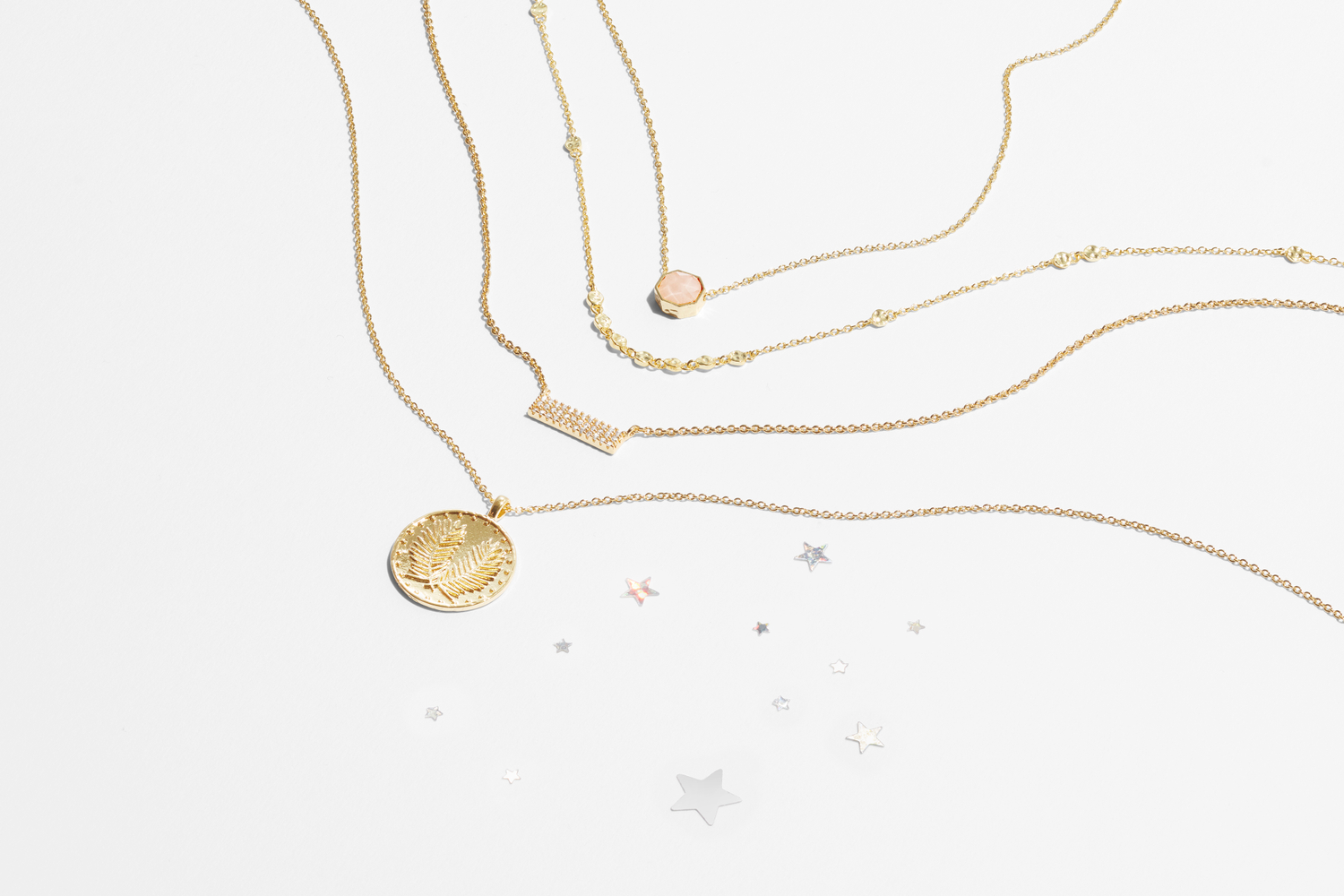 Beautiful gold fine jewelry photogaphed by top fashion photographer in Seattle gold necklaces with various pendants