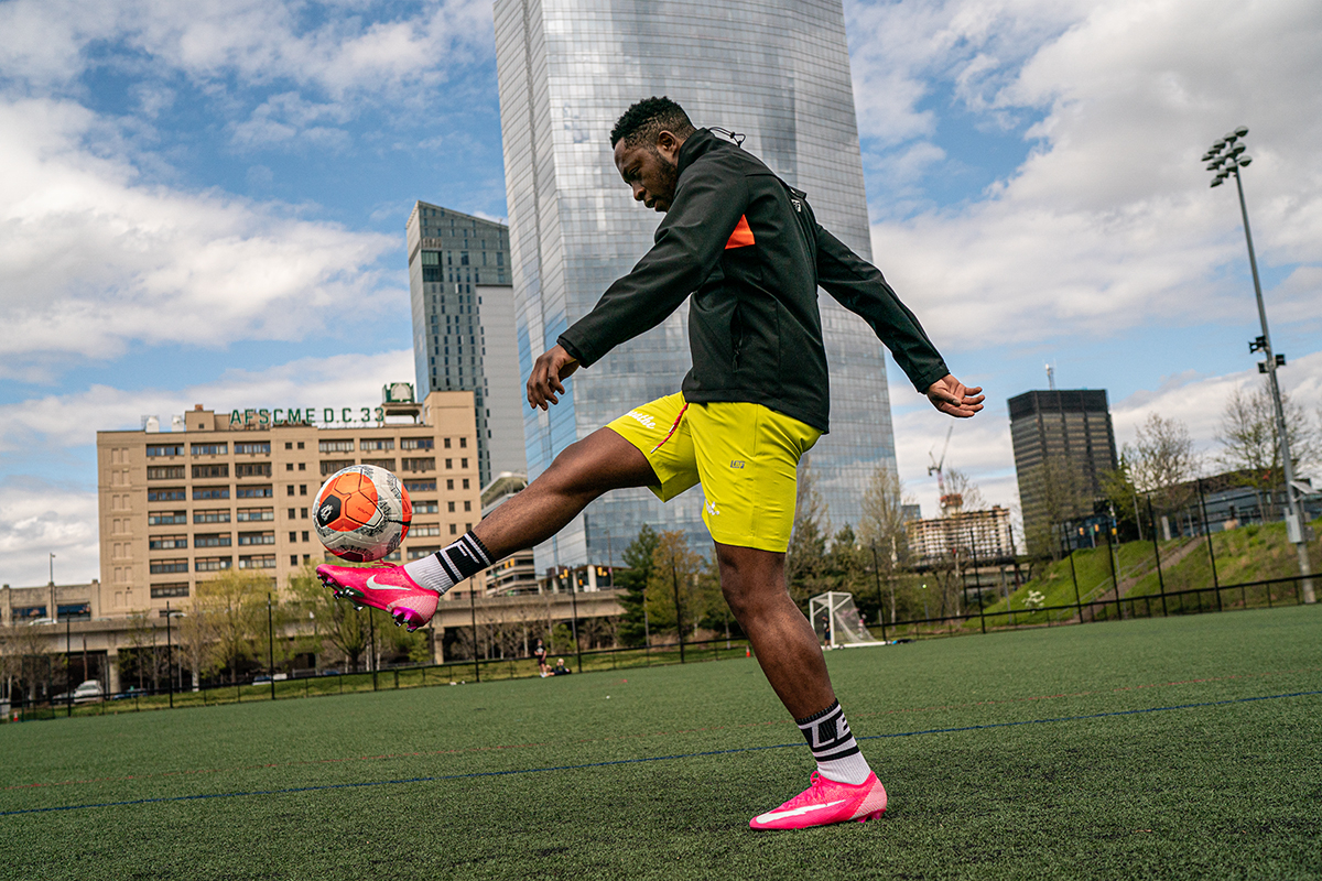 black soccer player warms up on an outdoor field 