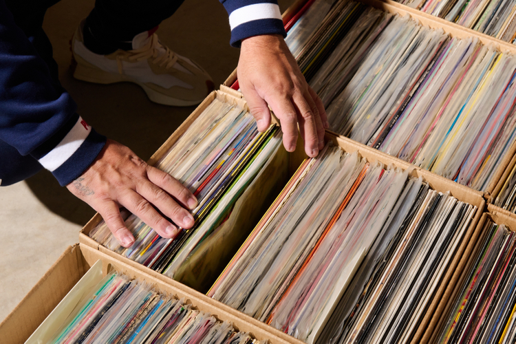 Hands sift through records 