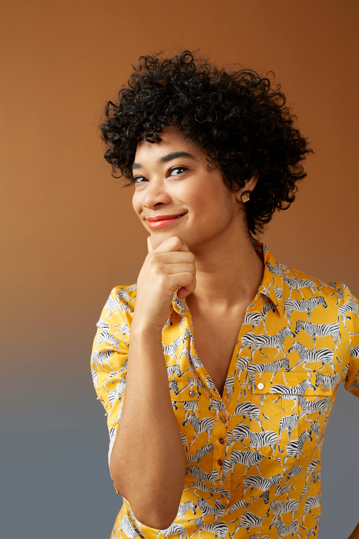 young woman poses in front of ombre backdrop photographed by Stanton Stephens