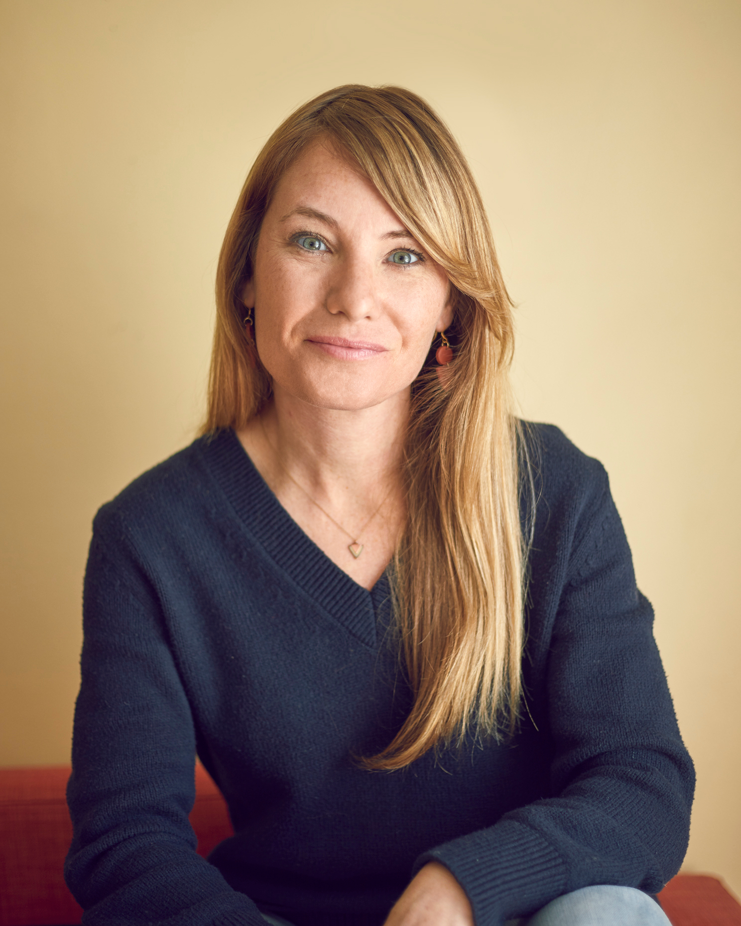 portrait of a woman on a yellow backdrop 
