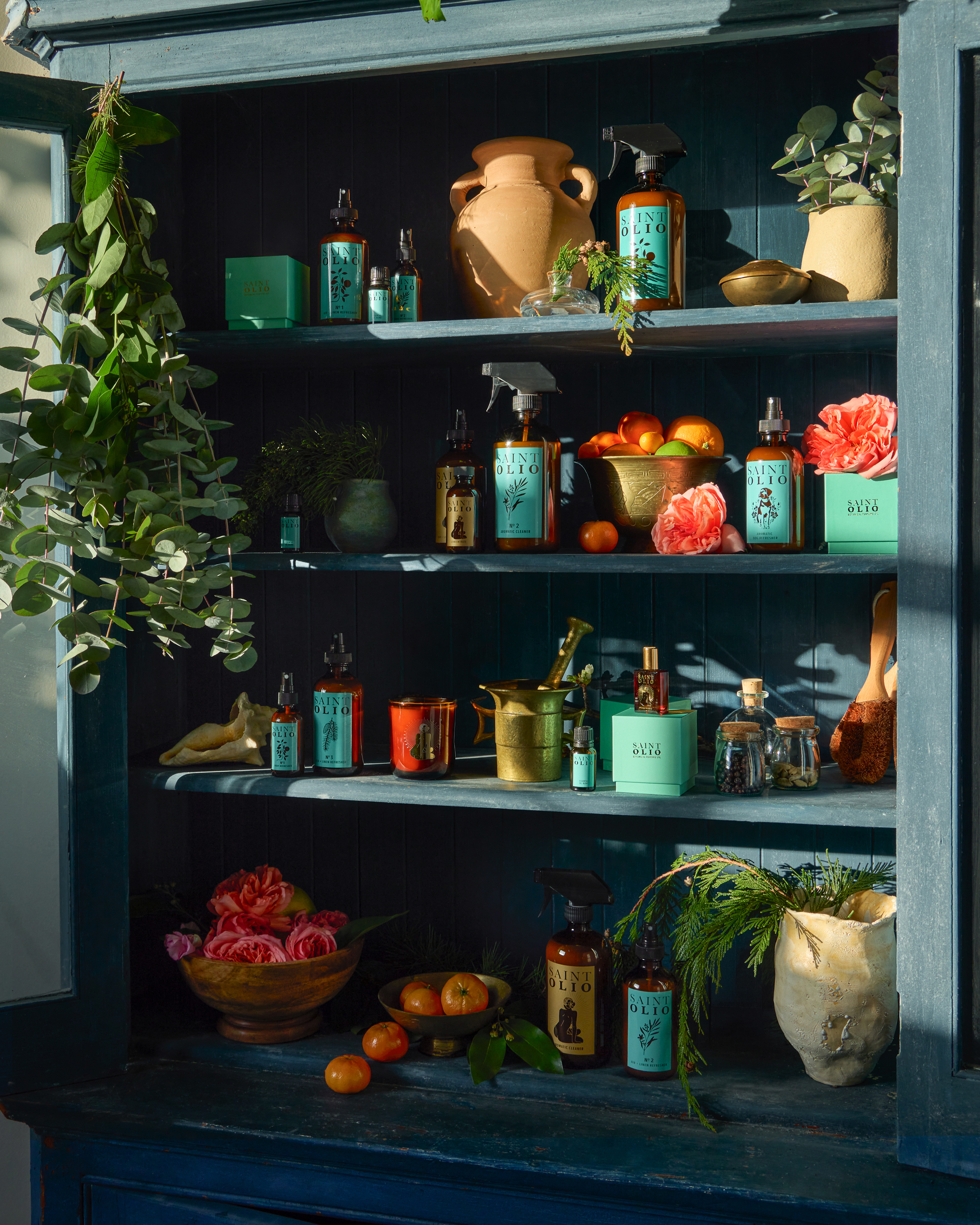 book shelving filled with saint olio products and fragrance ingrediants 