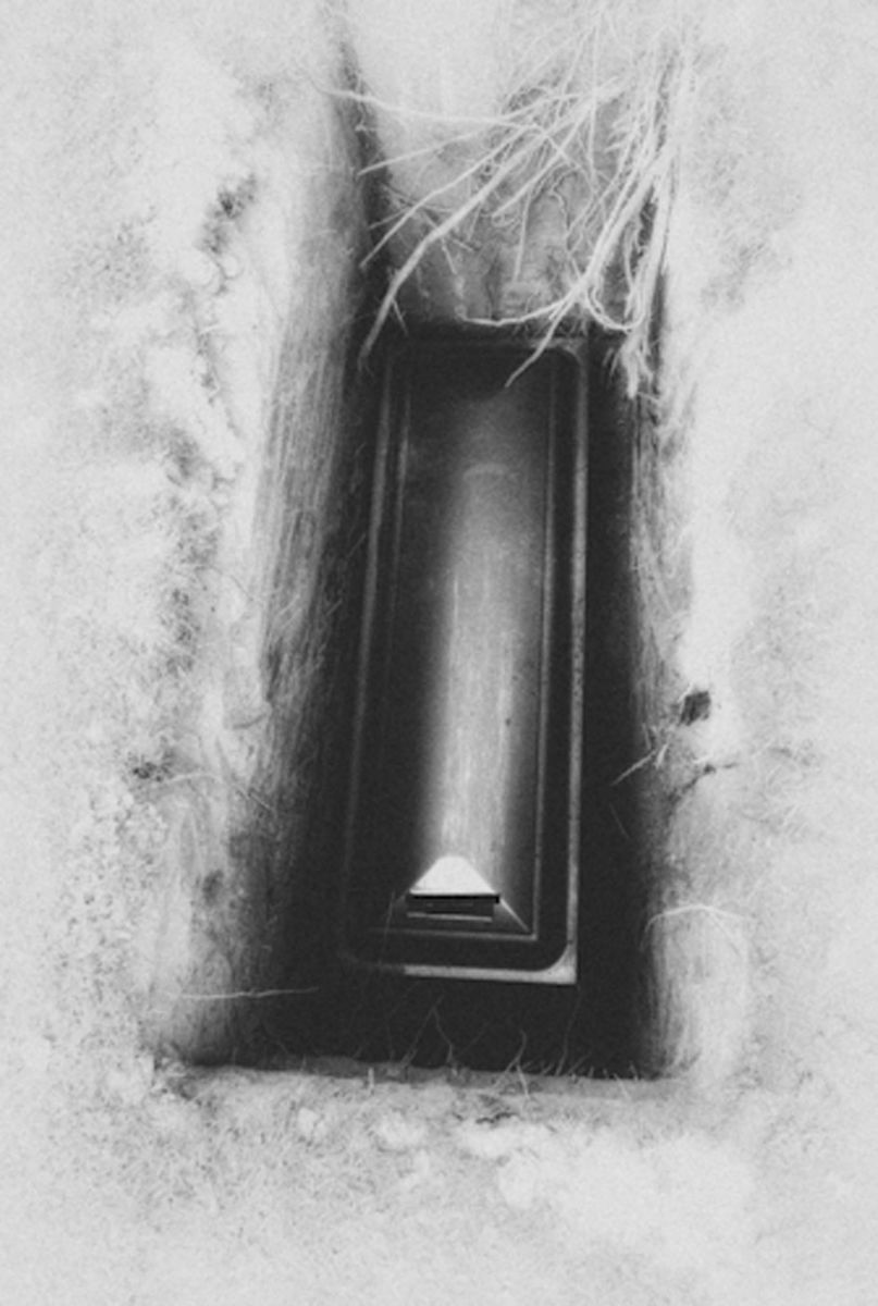 Black-and-white photograph of a coffin inside a grave, from Micha Warren’s artist book God Is Never Far Away, confronting mortality, memory, and the weight of loss. Coffin in grave – “God Is Never Far Away”