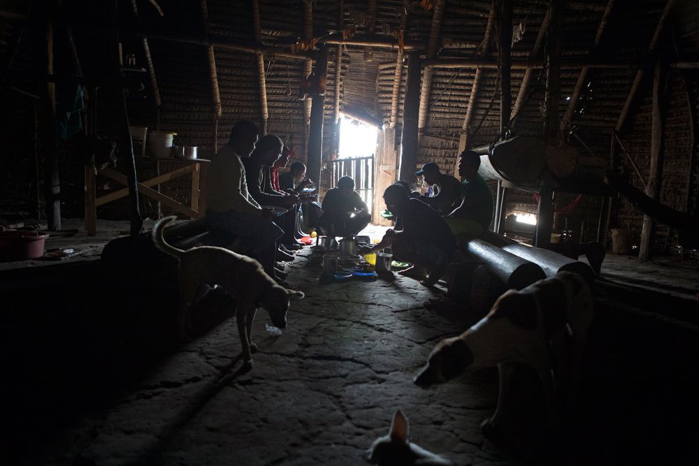 The Funai expedition team sit down to eat inside the Rio Novo village Moloca. Amazon