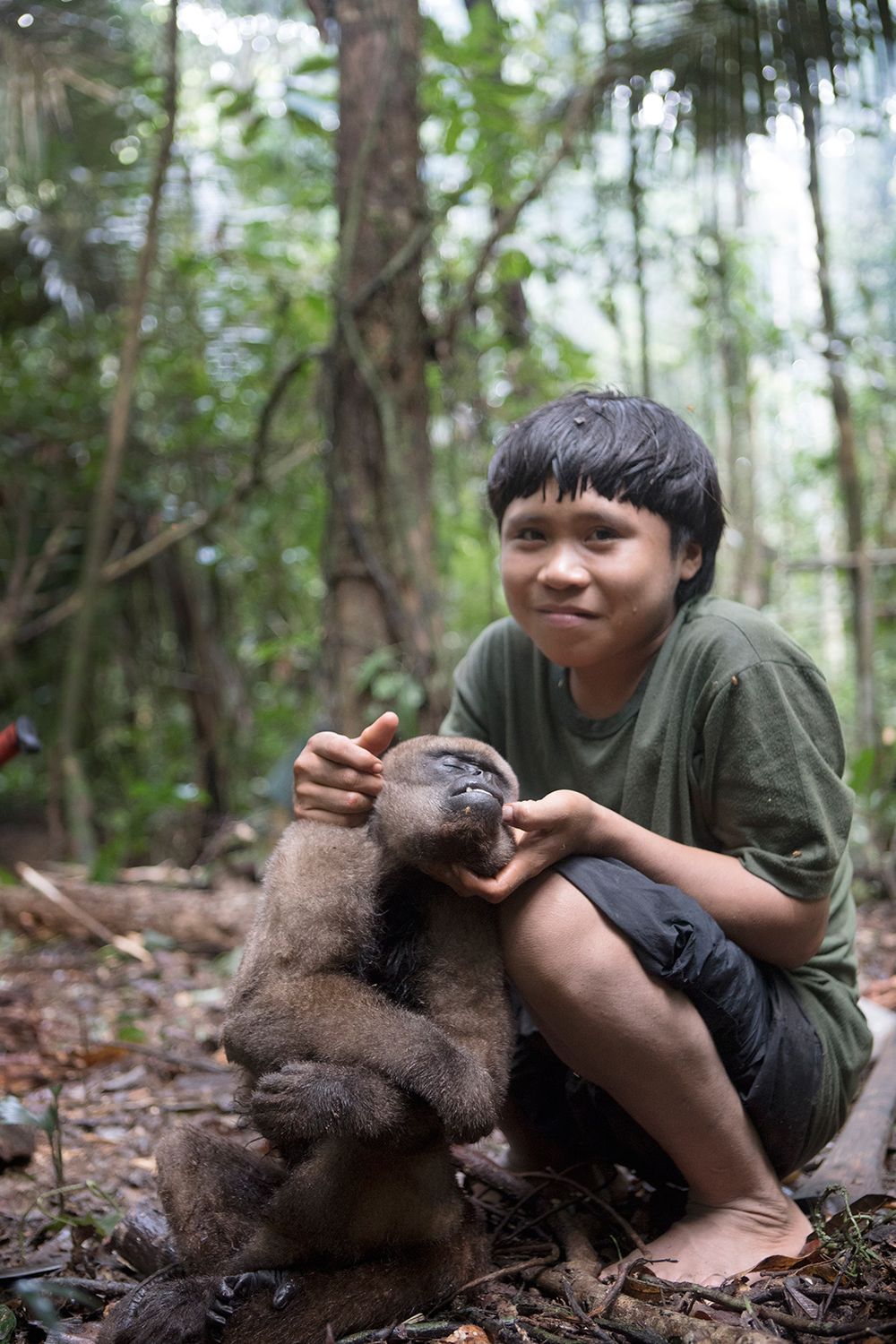 Young Korubo boy Xikxuvo Vakwë with a Macaco-Barrigudo or 'Fat Bellied Monkey,' which had been hunted during the days treks through the Vale do Javari. Amazon