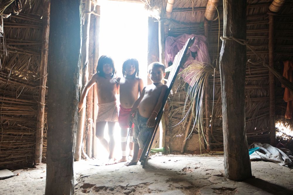 Young Marubo children inside the Maloca in the Village of Rio Novo. Amazon