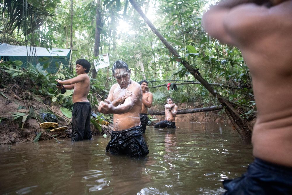 Members of the FUNAI team wash after the 4th days trek through the Vale do Javari. The days schedule was: wake up 5am, breakfast and decamp by 7am. Start trek until midday and rest. Trek until around 3pm and set camp and make diner, wash and dry clothes in the evening. Sleep in hammock by 8pm. Amazon