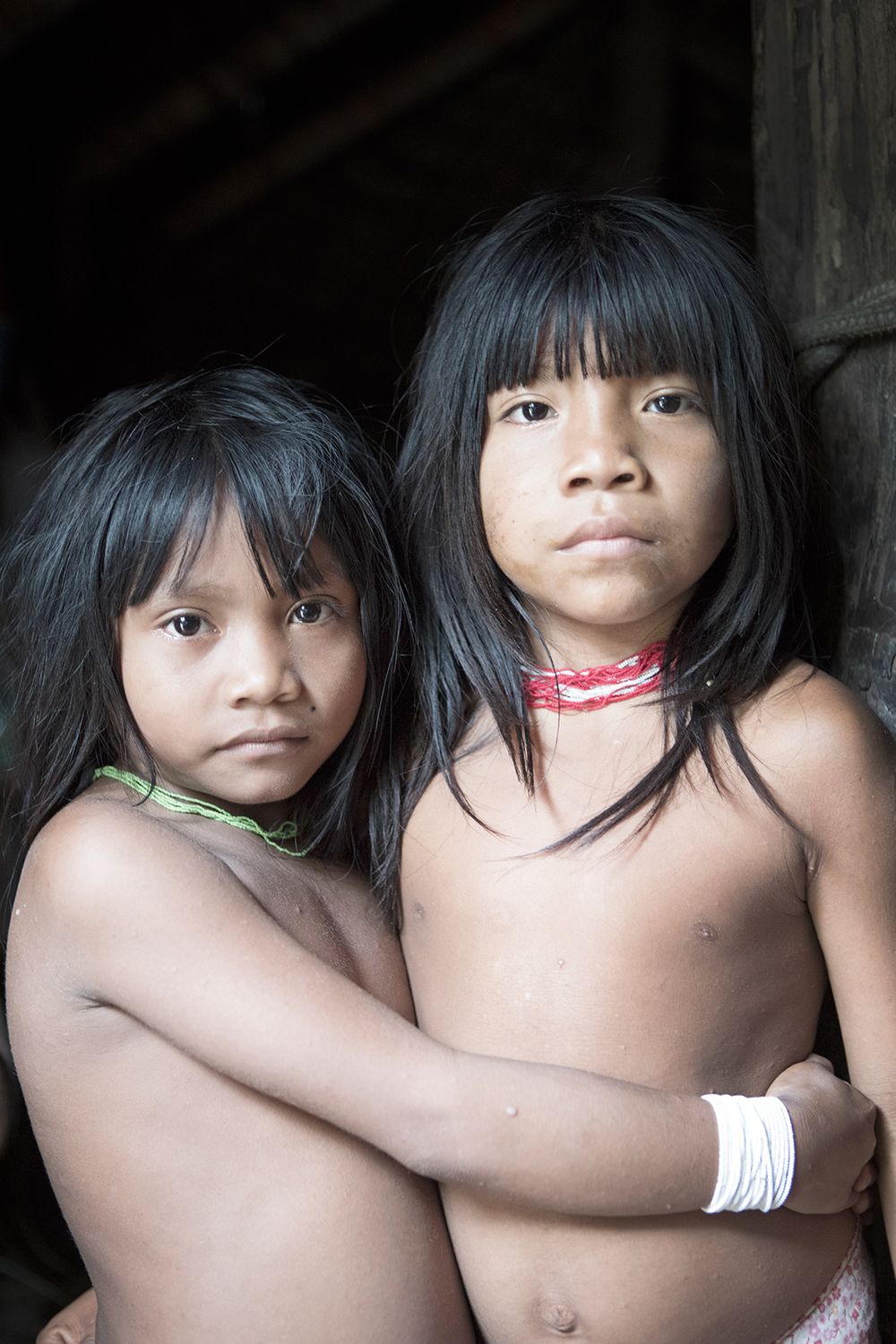 Two young Marubo girls and friends Iskasharoo Morubo (left) and Sheta Marubo (right) inside the Rio Novo village Moloca. Amazon