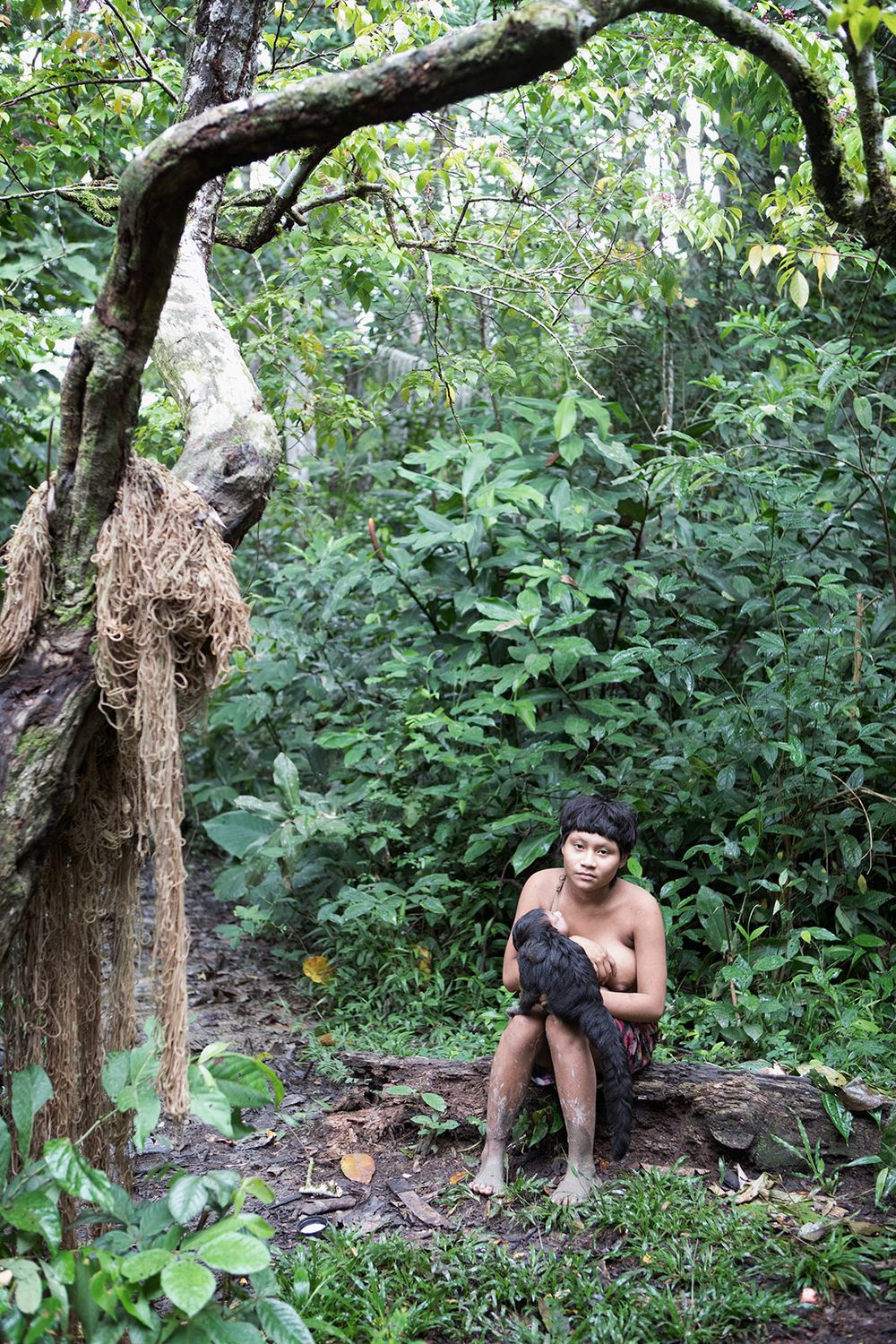 Young Korubo Mother, Tananeloanpikit with her child near to the entrance to the Korubo village alongside the Rio Itui. Amazon