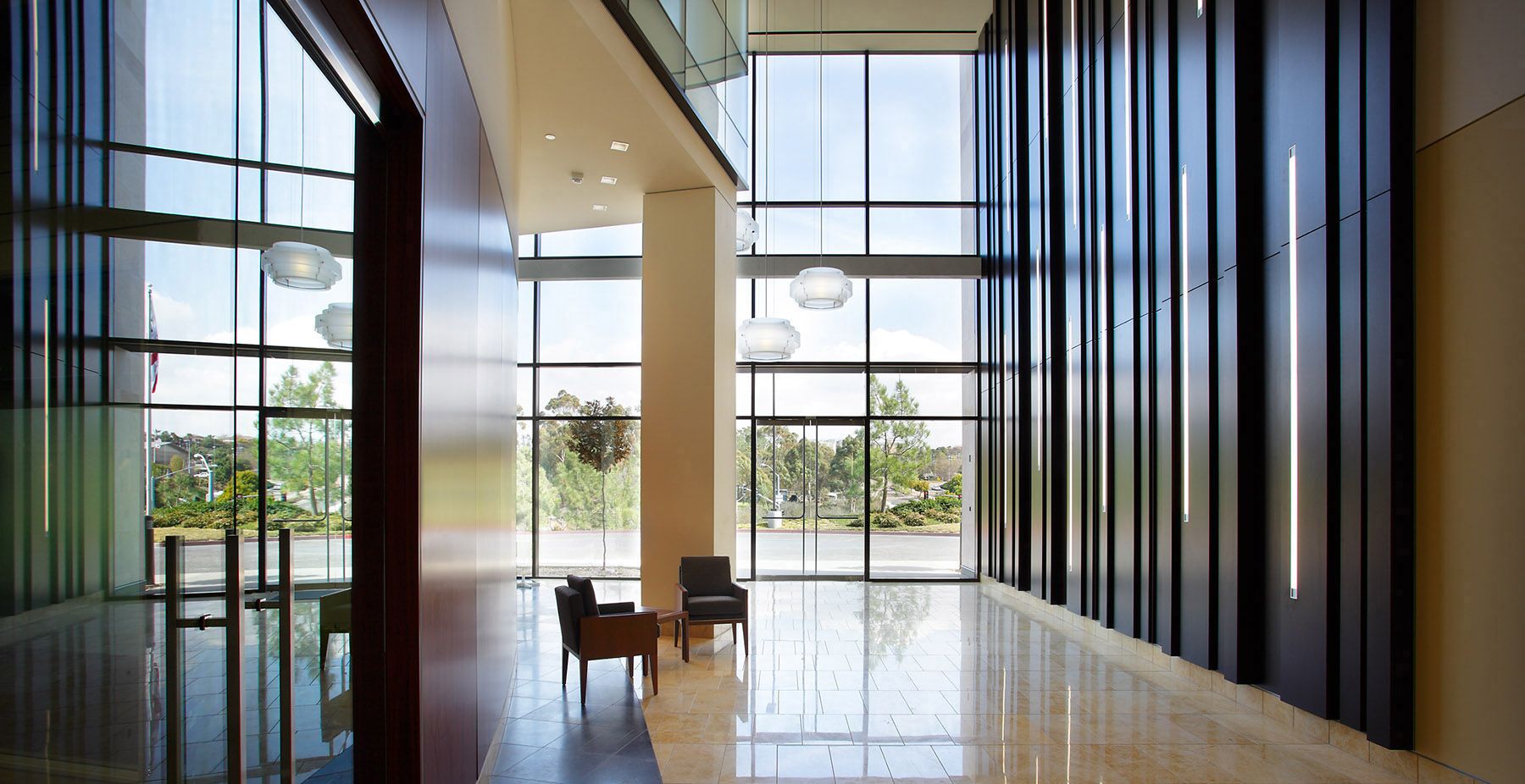 Commercial architectural photography of a modern, sunlit corporate building lobby in San Diego.
