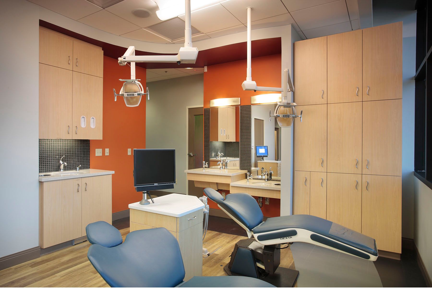 Modern dental operatory room with blue treatment chairs