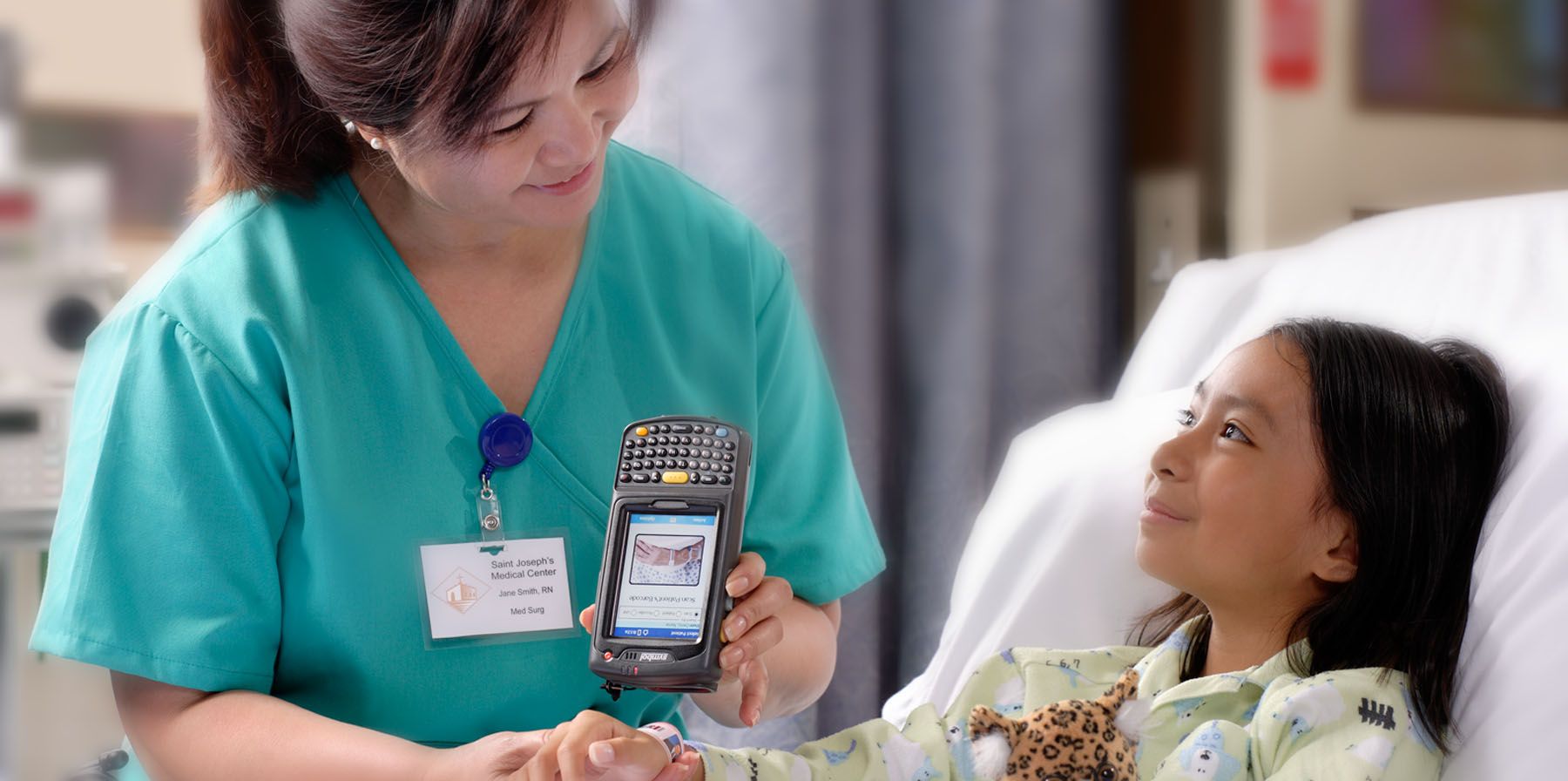 LOCATION SHOOT FOR CAREFUSION NURSE CARING FOR CHILD IN HOSPITAL BED SAN DIEGO PORTRAIT LIFESTYLE PHOTOGRAPHER