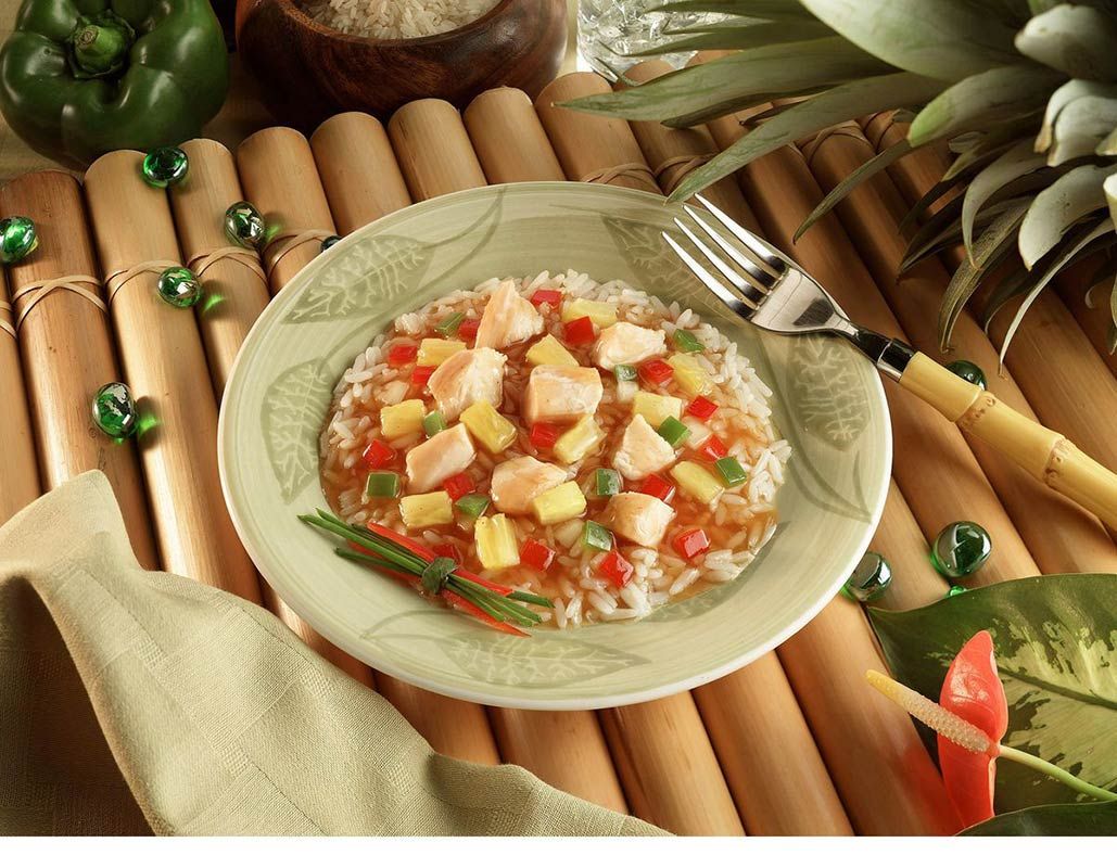 Commercial food photography of sweet and sour chicken with rice and pineapple