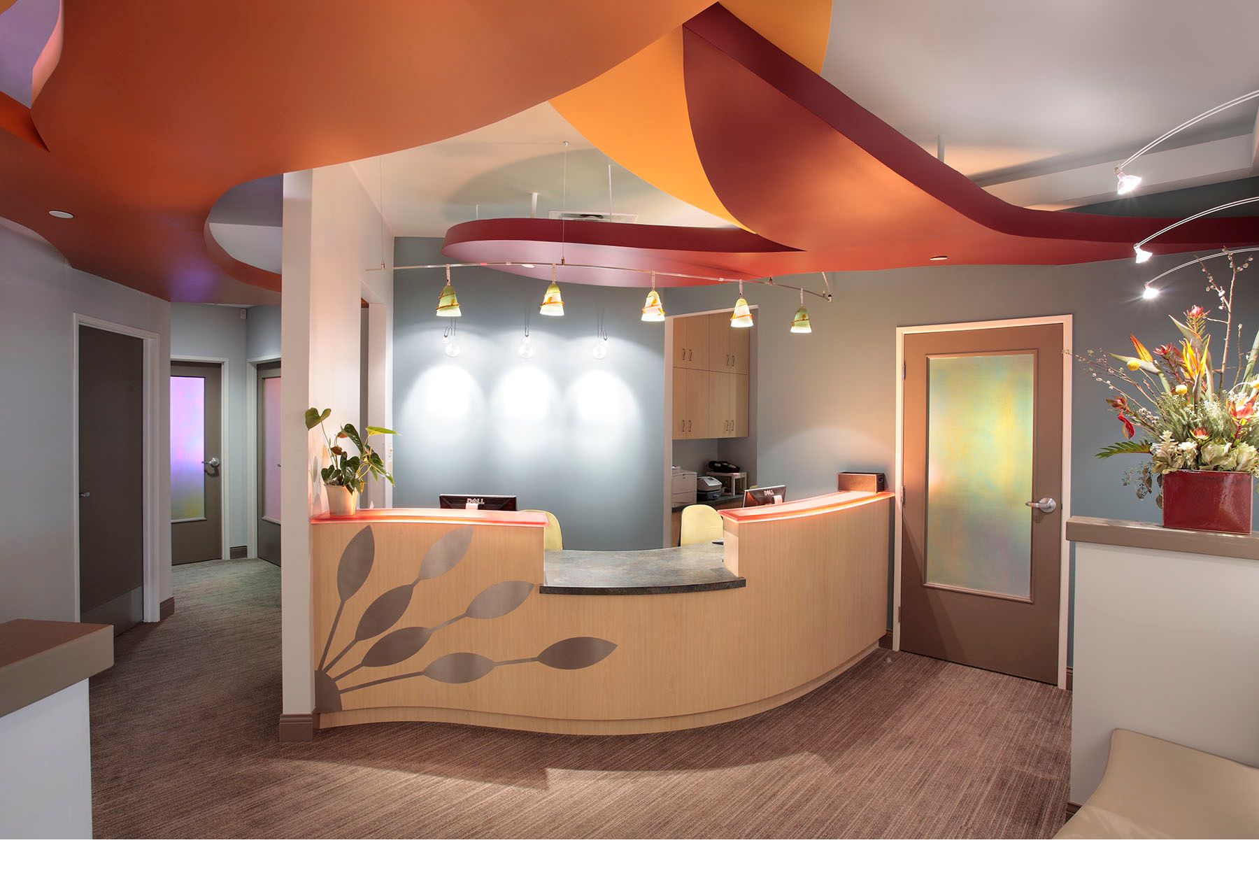 Modern dental office reception desk and waiting room area 