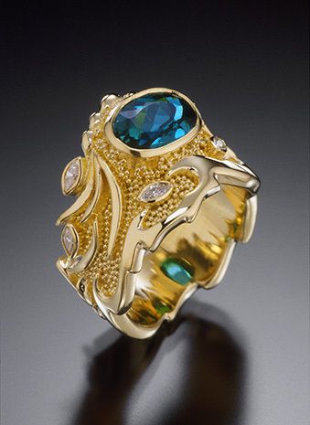 custom made in18k yellow gold with granulation, 9mm x 7mm indicolite tourmaline, marquise diamonds VS-G (total diamond weight 26 points), dimensions: taper varies 13.95mm to 5.2mm. GRANULATED OCEAN RING