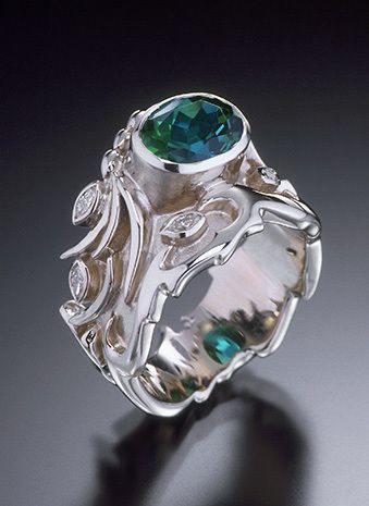 custom made in 18k white gold with polished and brushed satin finishes, 9mm x 7mm indicolite tourmaline, marquise diamonds VS-G (total diamond weight 26 points), dimensions: taper varies 13.95mm to 5.2mm. OCEAN RING