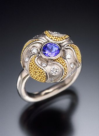 18k white gold with 20k yellow gold granulation, brushed satin finish, 5mm tanzanite, diamonds VS-F (total diamond weight 26 points), 16.7mm diameter. CUSHION RING