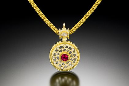 18k yellow gold with 20k yellow gold granulation, brushed satin finish, ruby, diamonds VS/F/G (total diamond weight 30 points), 18k yellow gold handmade woven chain, dimensions: 1.3”H x 0.82”W x 0.36”D. CLOCK TOWER PENDANT