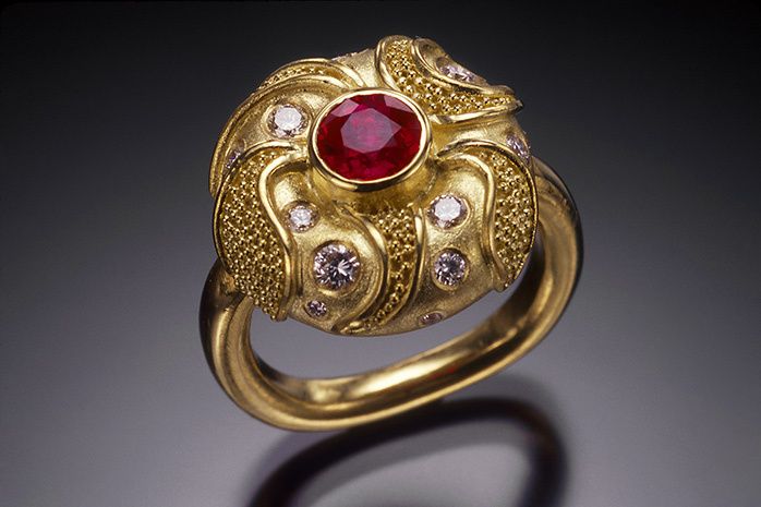 18k yellow gold with granulation, brushed satin finish, 5mm ruby, diamonds VS-F (total diamond weight 26 points), 16.7mm diameter. CUSHION RING