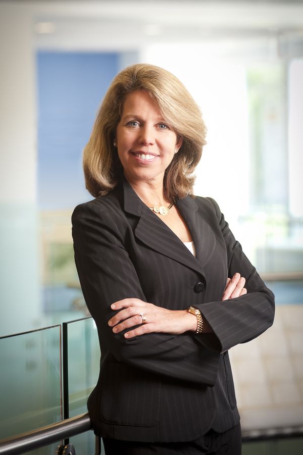 Maliz Beams smiles with arms crossed at Voya headquarters in Windsor CT Maliz Seems Voya CEO