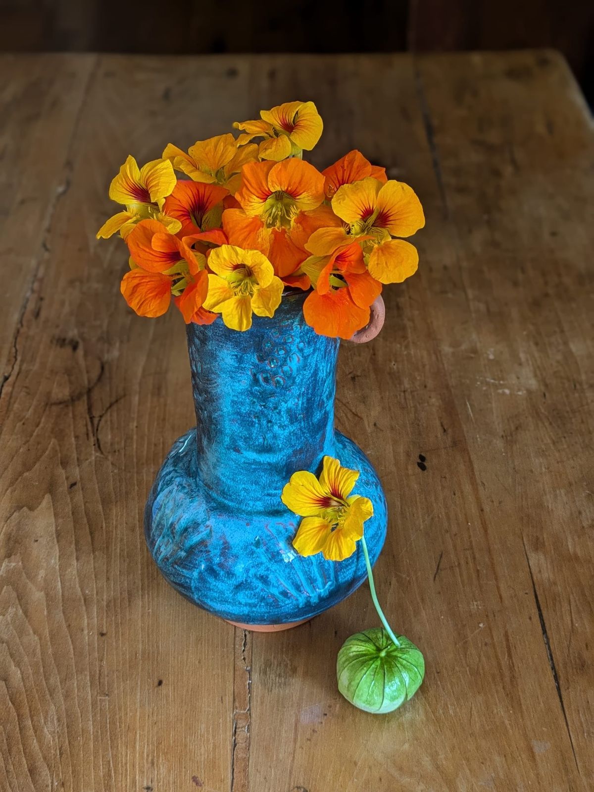Edible Nausturtium And Tomatillo On Farm Table