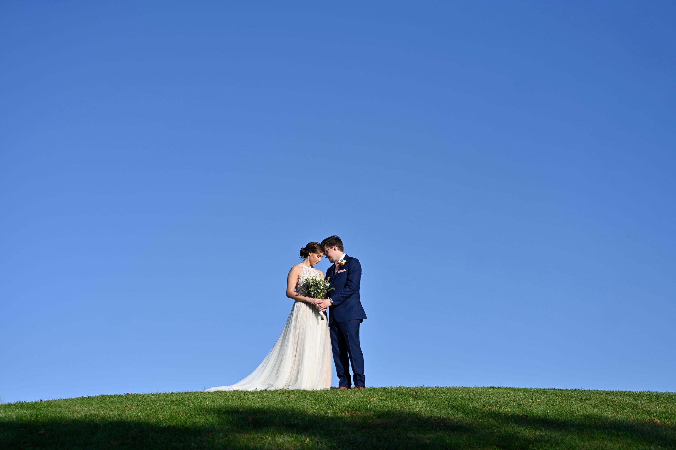 Wedding Embrace Against The Blue Sky