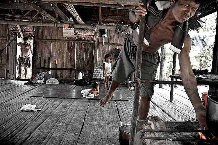 Sequoia man tends the cook stove at his home on a Sequoia Reservation near Santa Maria on the Rio Napo Peru 1sequoia_firepit_peru