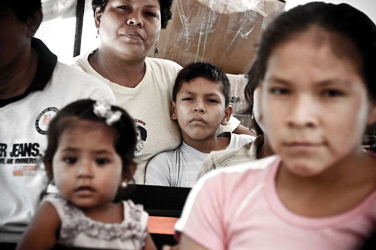 Boy and his mother taking the daily river bus near Mazan on the confluence of the Rio Napo and the Amazon Peru 1son_amazon_peru