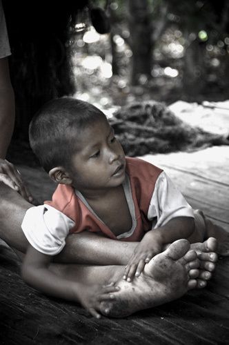Child in his family home on the banks of the Rio Napo near San Martin Peru 1rio_napo_child_foot