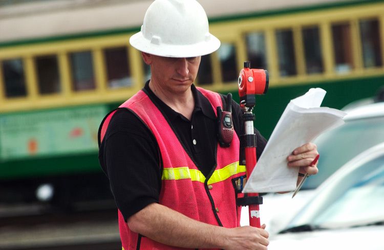 Man Surveying on Public Street