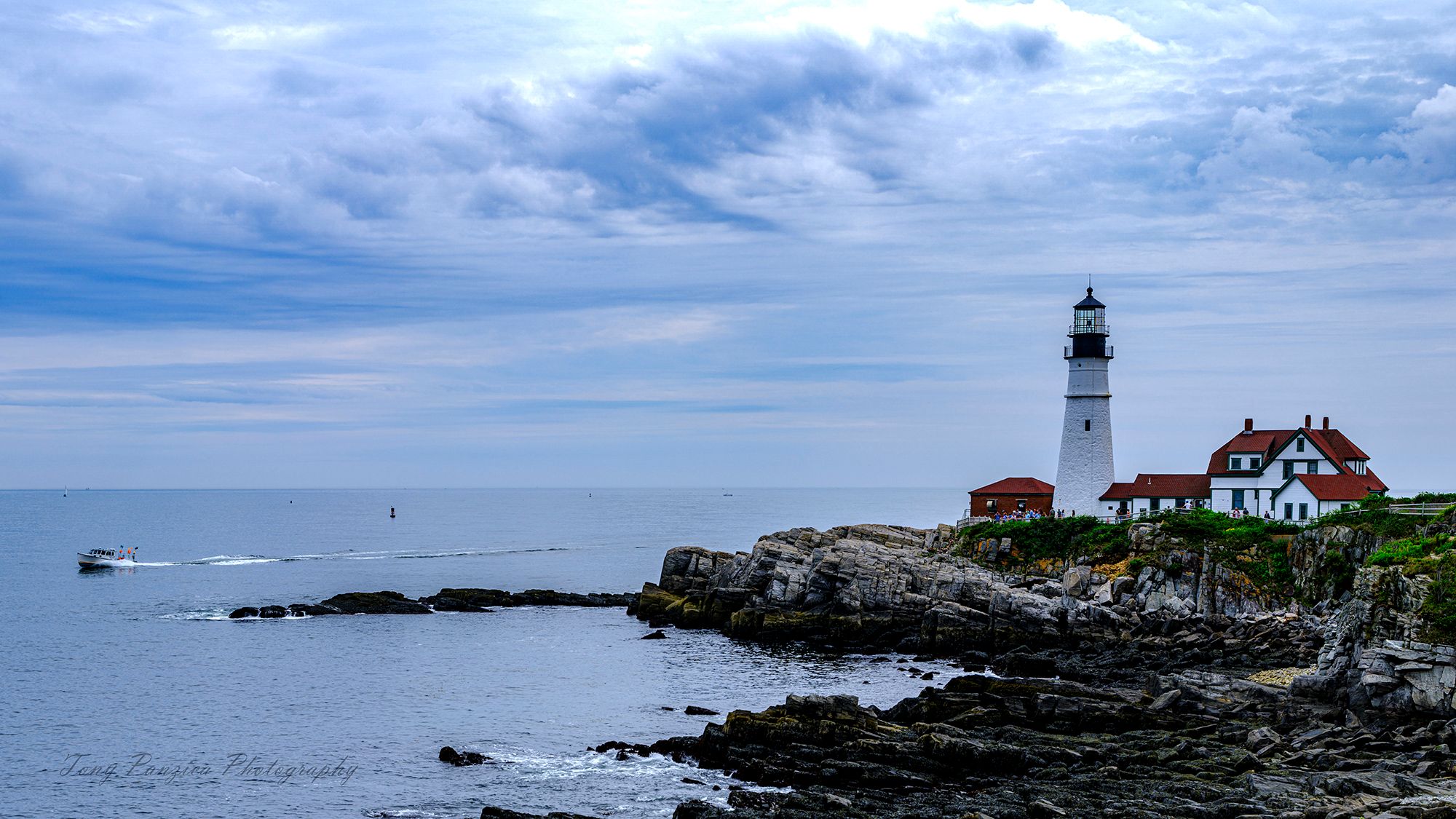 Cape Elizabeth is the home of Portland Head Light. Situated along the spectacular shores of Fort Williams Park,  the popular landmark is owned and managed by the Town of Cape Elizabeth, Maine.  Thanks to the skipper of the small boat for adding a nice finish to an amazing location.  Portland Head Light House