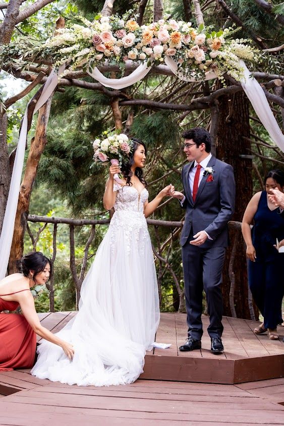 Bride and Groom under flowers