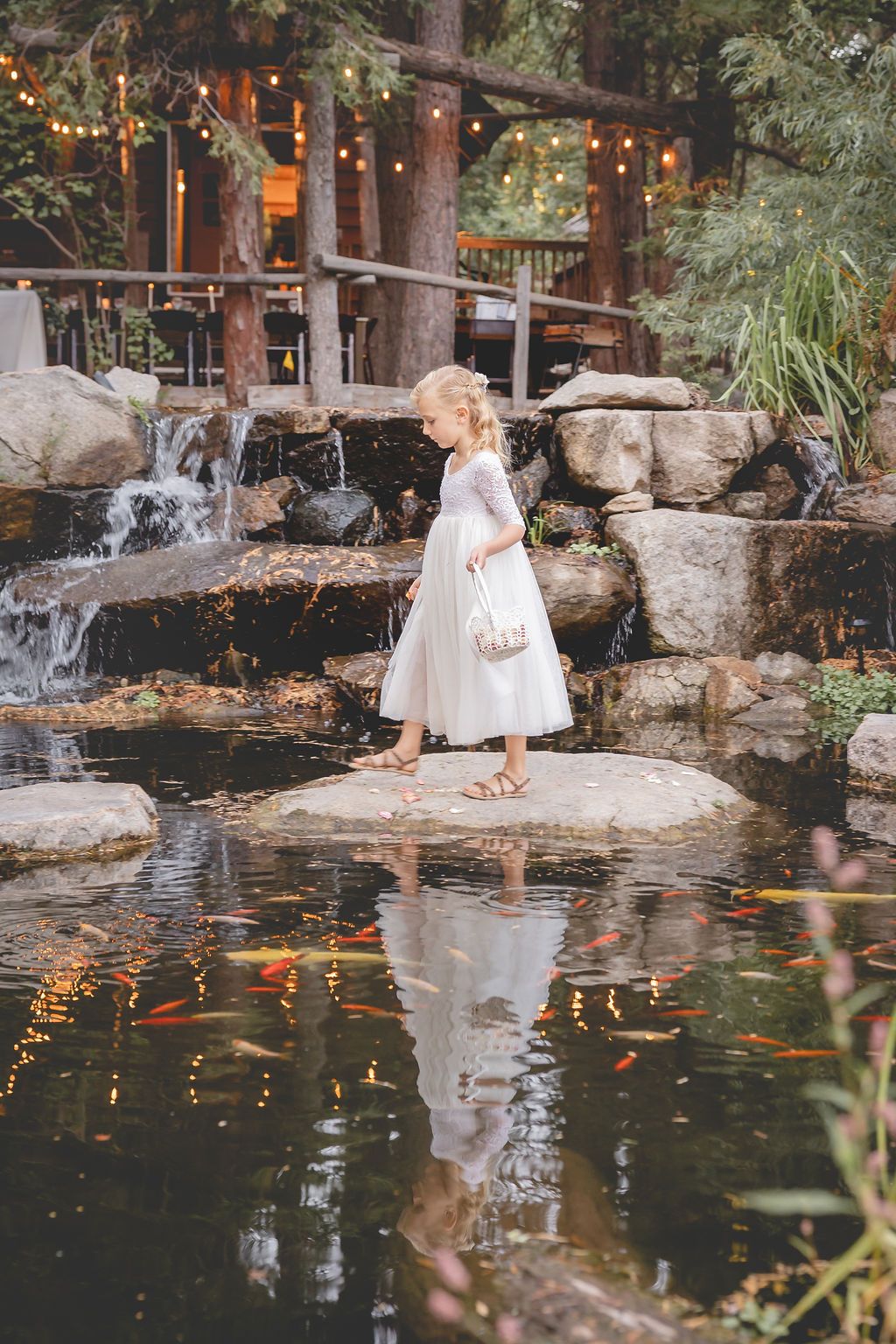 Girl walking on stones across pond.jpg
