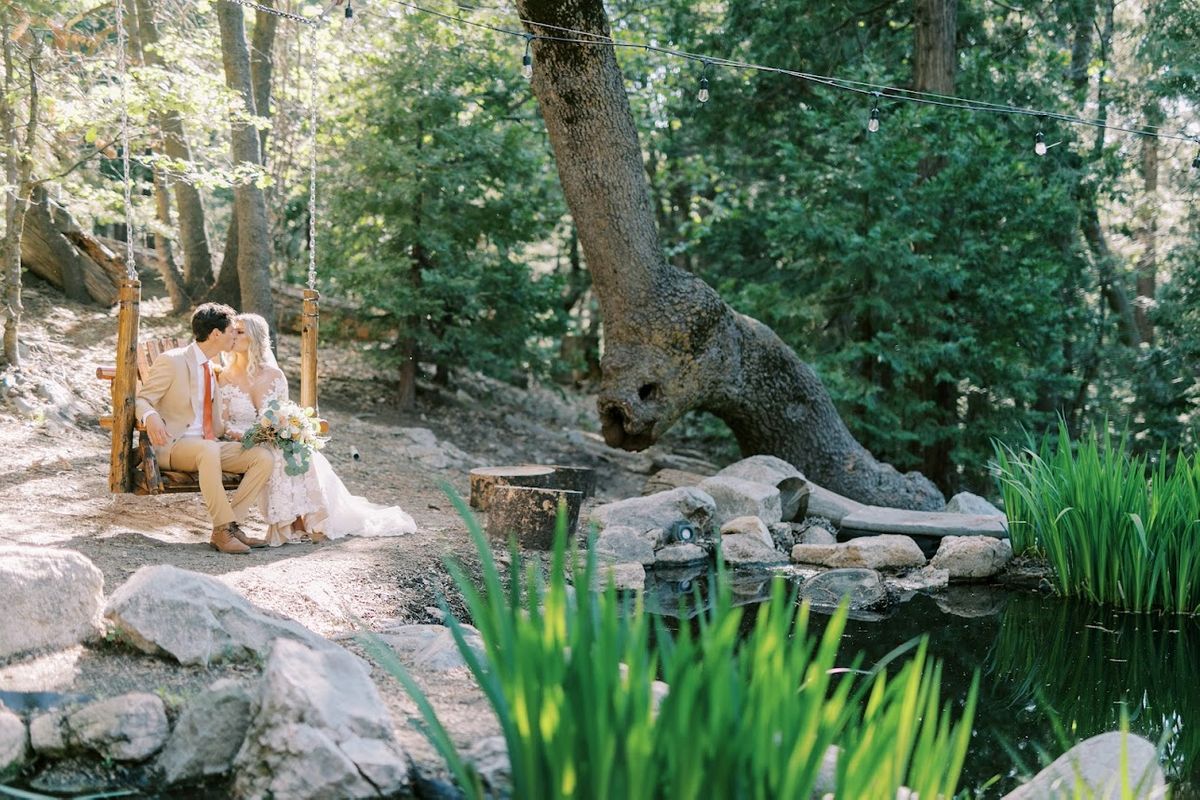 Bride and Groom swinging in forest.jpeg