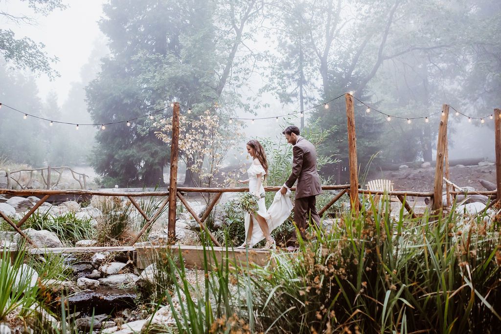 Couple walking on the bridge in the fog