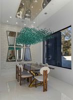 13-atlanta-modern-luxury-estate-emerald-chandelier-dining-angle.jpg