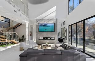 08-atlanta-modern-luxury-estate-double-height-living-room-fireplace.jpg