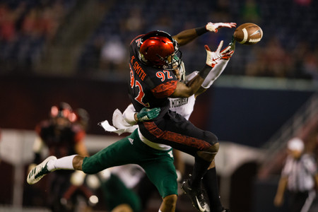 A pass is broken up during a football game between san diego state and eastern michigan Fingertip Pass Deflection