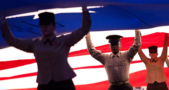 Members of the military hold up a field sized American flag prior to the Pacific Life Holiday Bowl. NCAA FOOTBALL: Pacific Life Holiday Bowl - Arizona v Nebraska