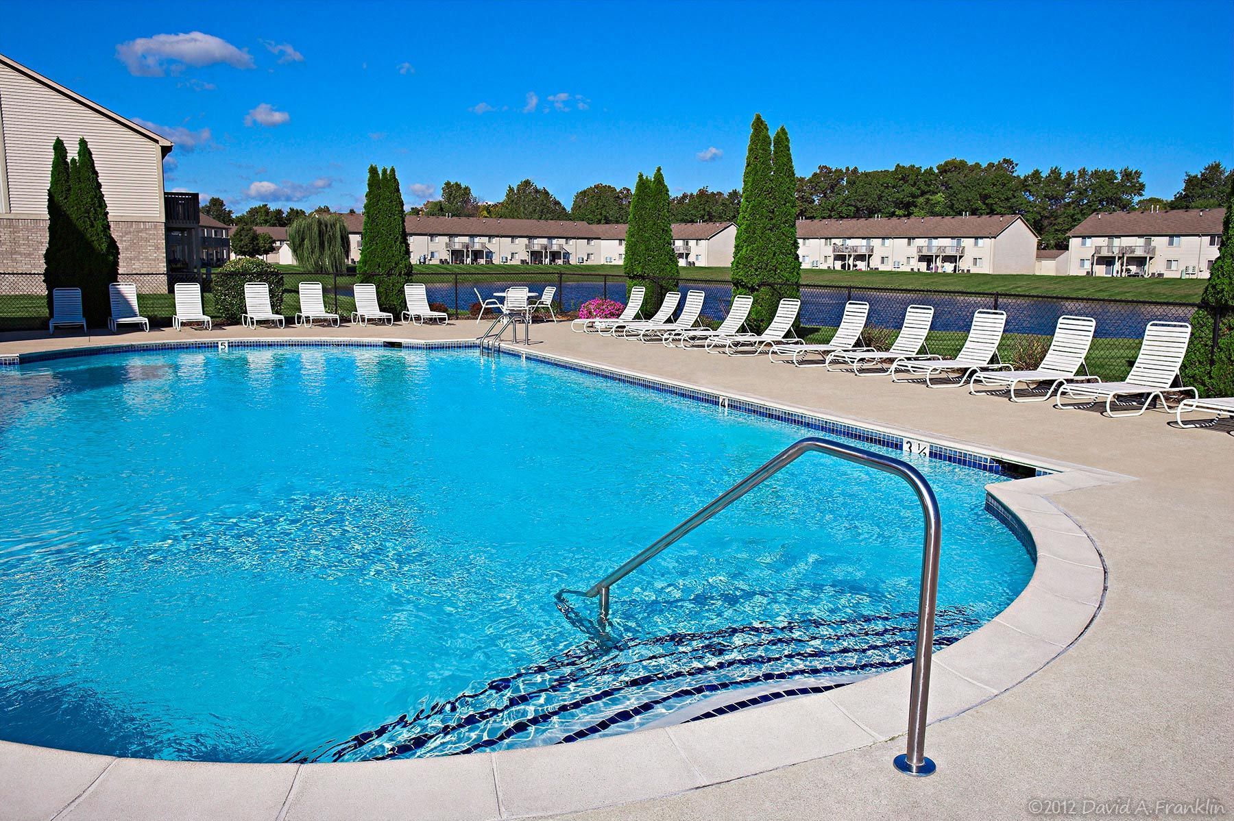 ApartmentComplex_Exterior_PebbleCreek_Pool&Recliners&Environs_LeasingBrochure