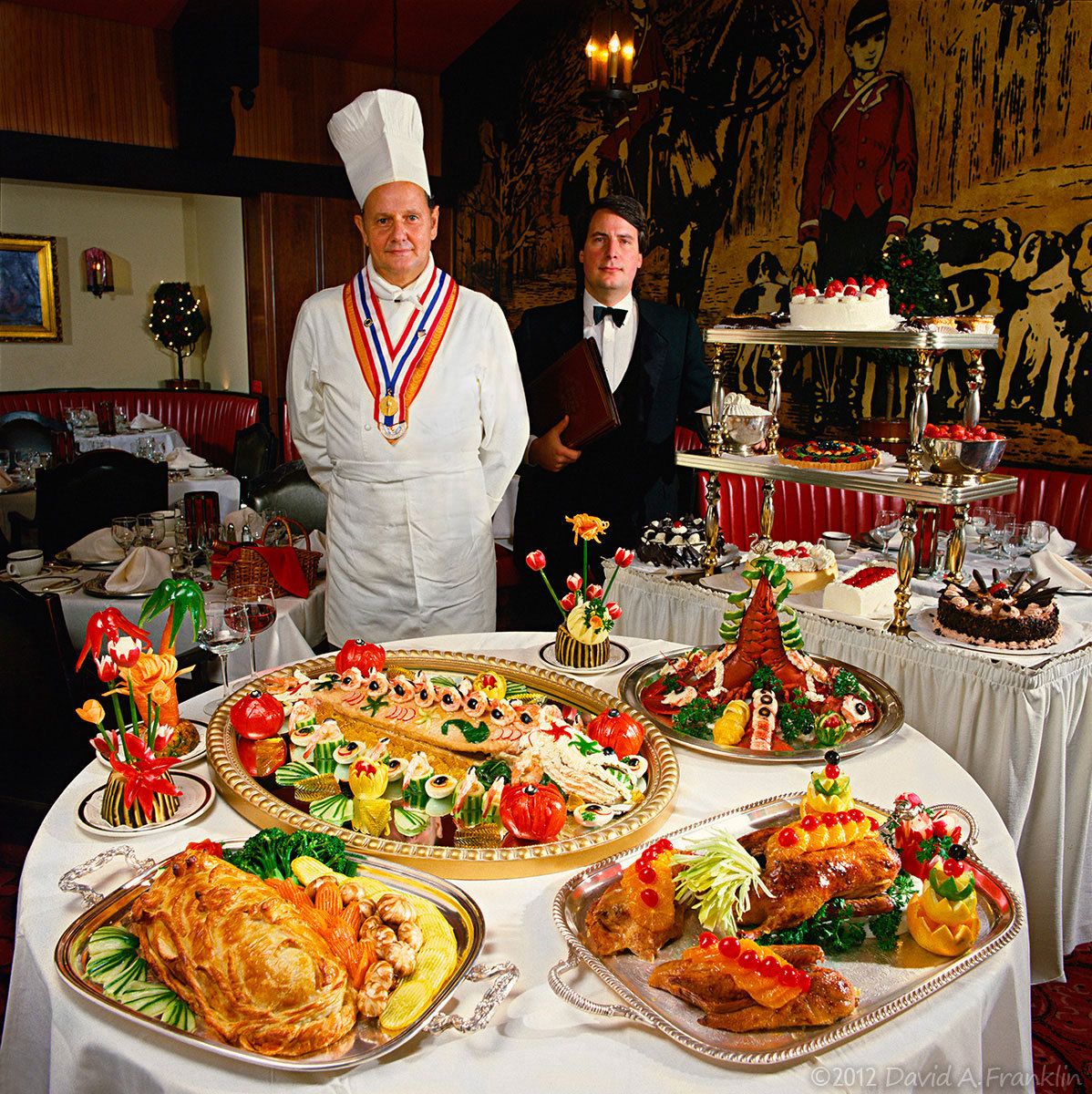 ChefLeopoldSchaeli&MaitreDe_ElaborateClassicEuropeanCuisine_ArrangedAtTable&Cart_MachusRedFox_Editorial