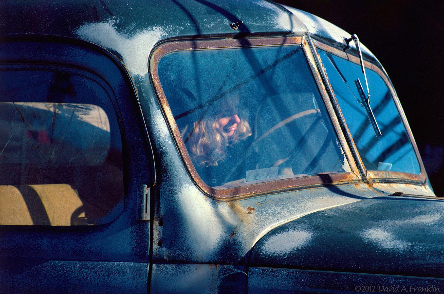 DowncastWoman_ThroughWindshield_OldRustedTruck_Personal
