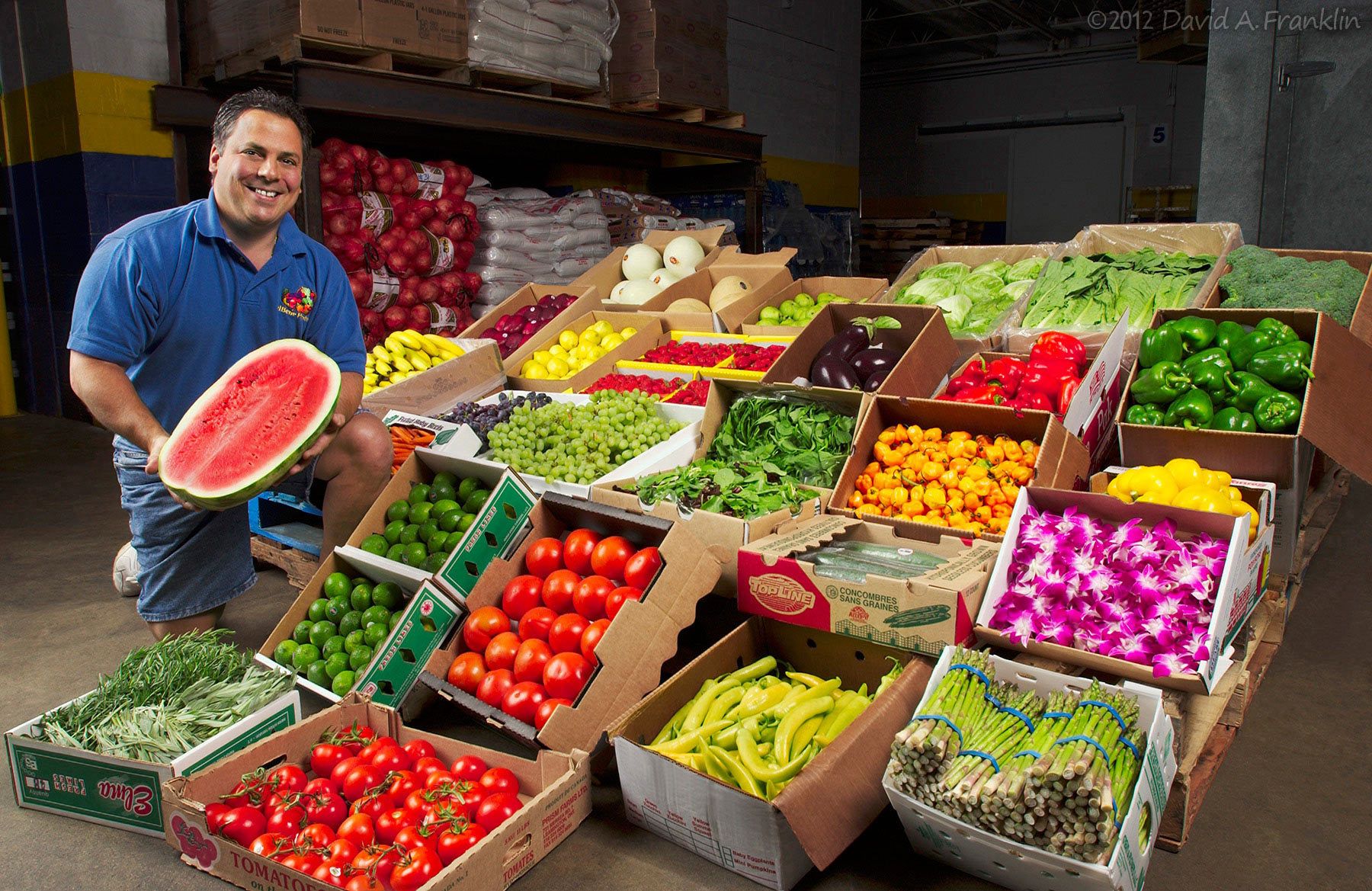 WholesaleProduceSupplier_InWharehouse_ShowsFruits&Vegetables_Advertising