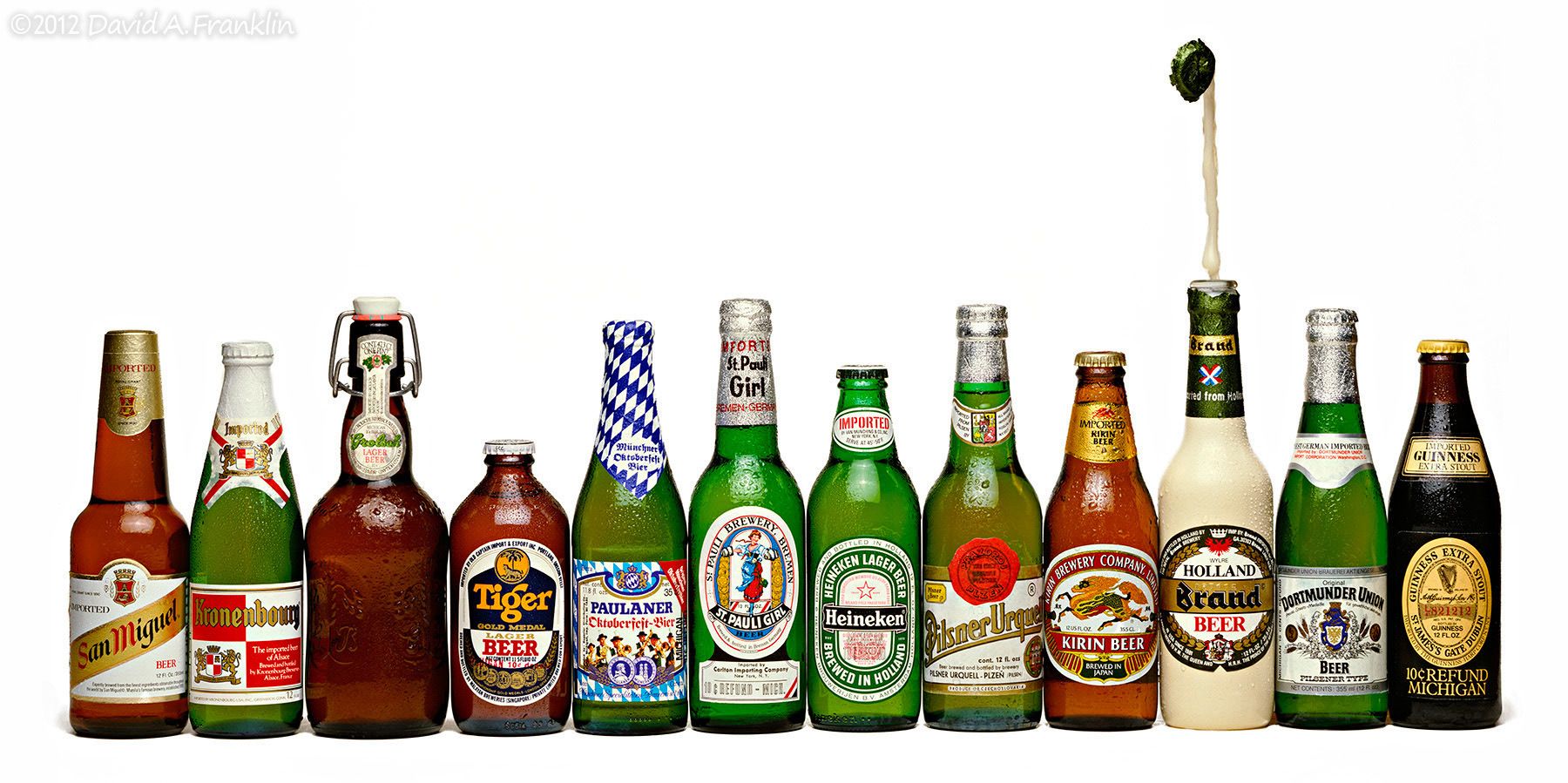 LineUp_ImportedBeerBottles_PoppedBottleTopReleasesPlumeOfBeer_Editorial