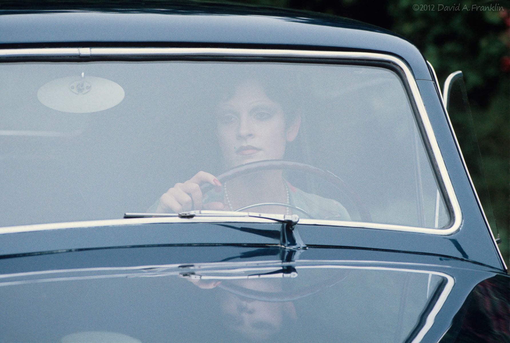 FemaleModel_PeriodDress_StaringSerenelyThroughWindshield_1941Lincoln_Personal