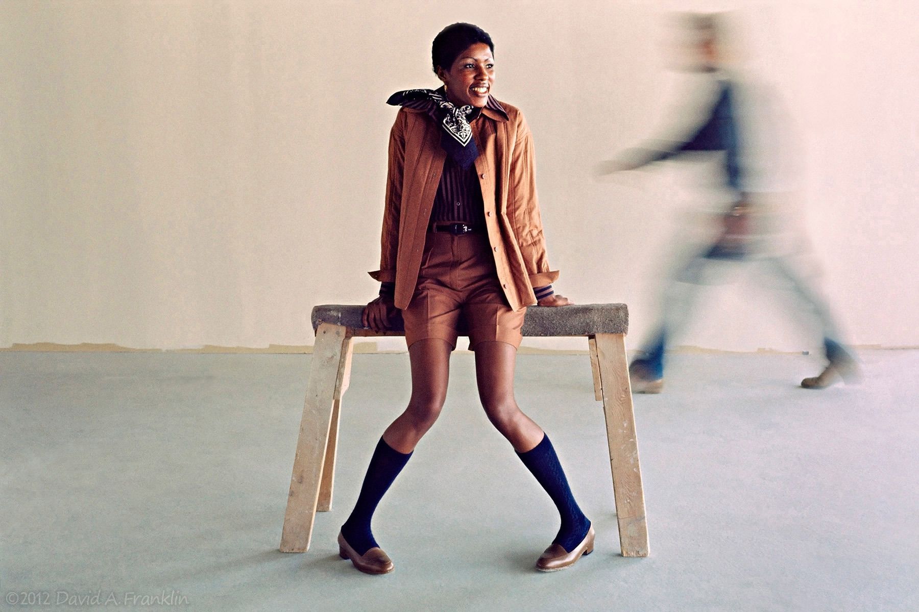 Fashion_YoungWoman_SittingOnSawhorse_MotionBlurredWorker_Editorial