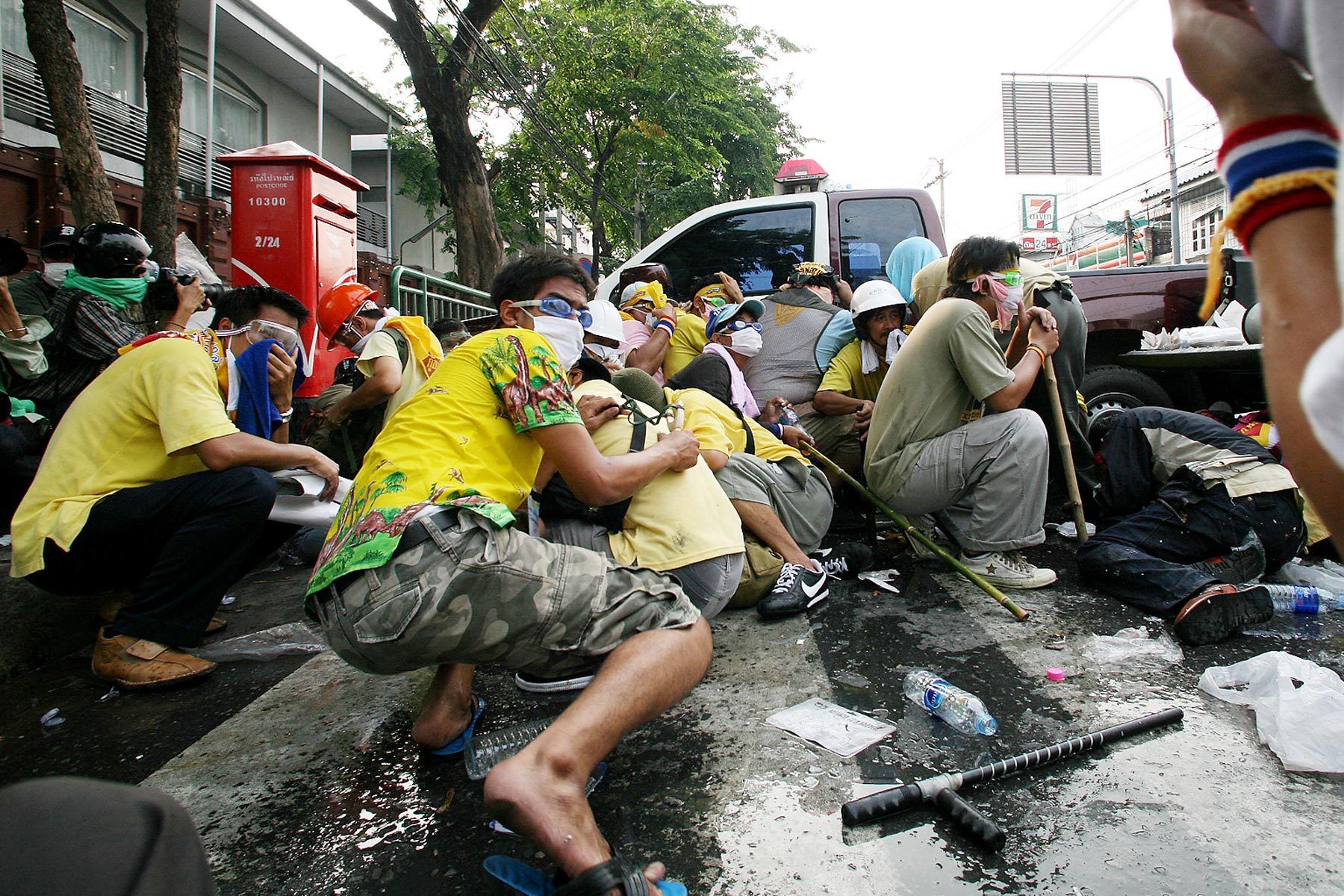 Demonstrators of People's Alliance for Democracy (PAD) shelter from tear gas. 