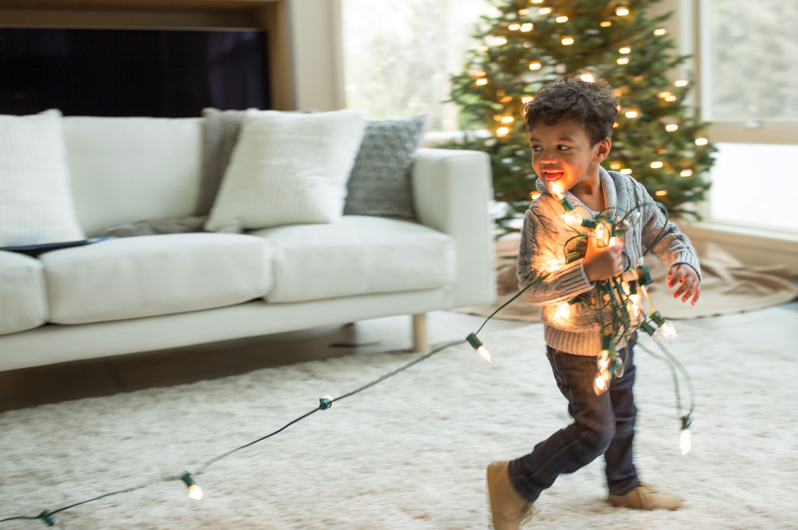 Child with Christmas lights